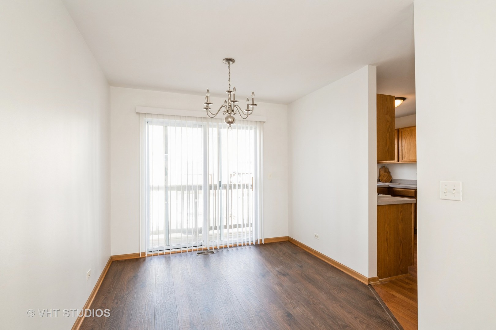 34296 North Barberry Road Round Lake, IL 60073 - Photo 3 of 10 an empty room with wooden floor chandelier and windows