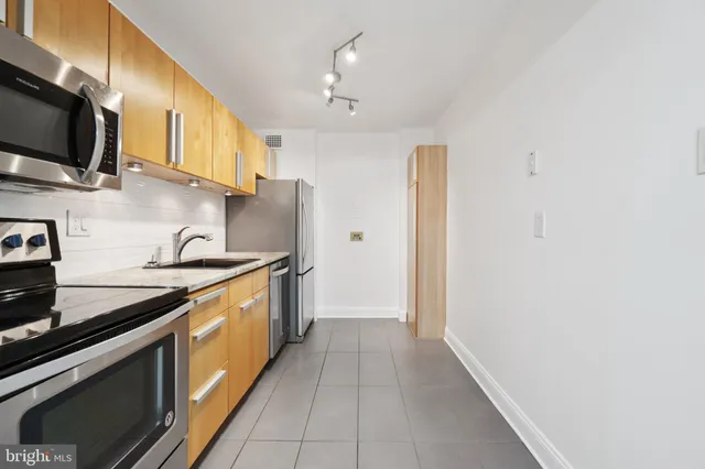 a kitchen with stainless steel appliances granite countertop a sink and a stove
