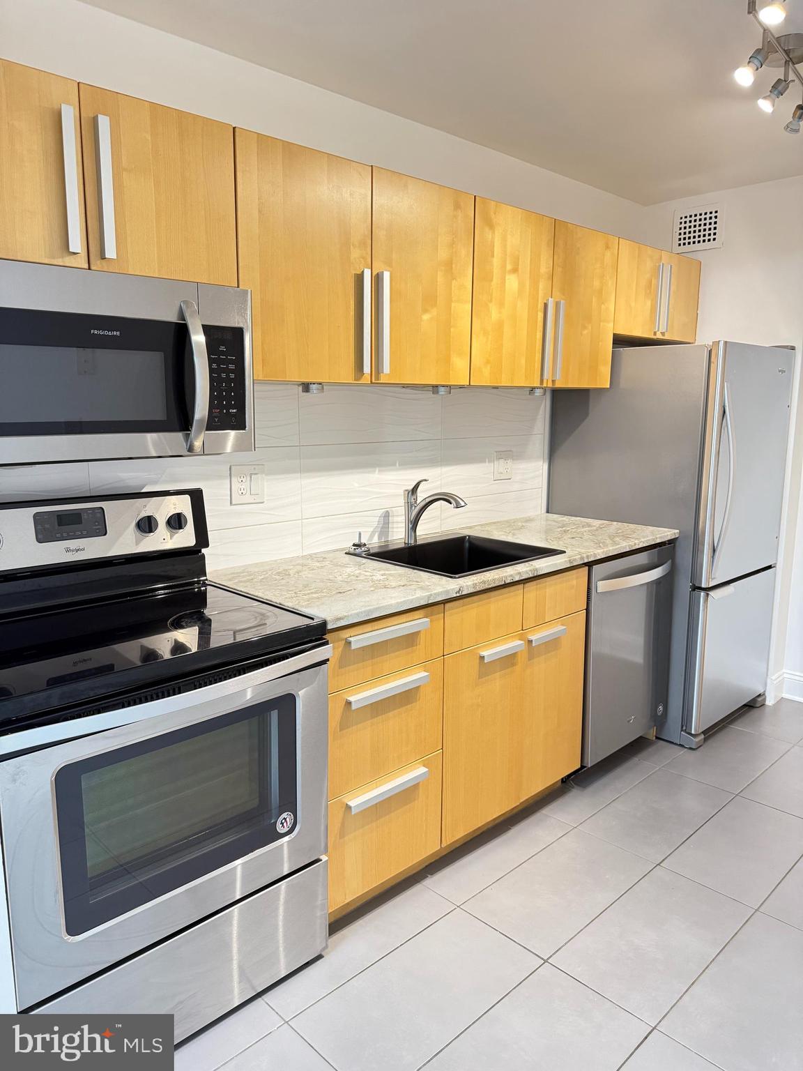 2059 Huntington Avenue, Unit 111 Alexandria, VA 22303 - Photo 15 of 34 a kitchen with stainless steel appliances a stove sink and microwave