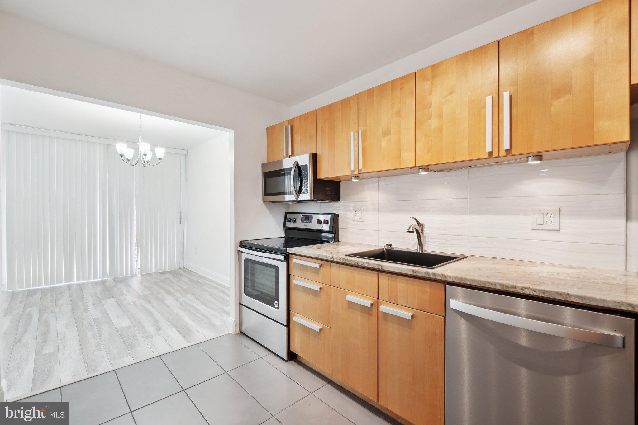 2059 Huntington Avenue, Unit 111 Alexandria, VA 22303 - Photo 17 of 34 a kitchen with stainless steel appliances granite countertop a sink stove and refrigerator