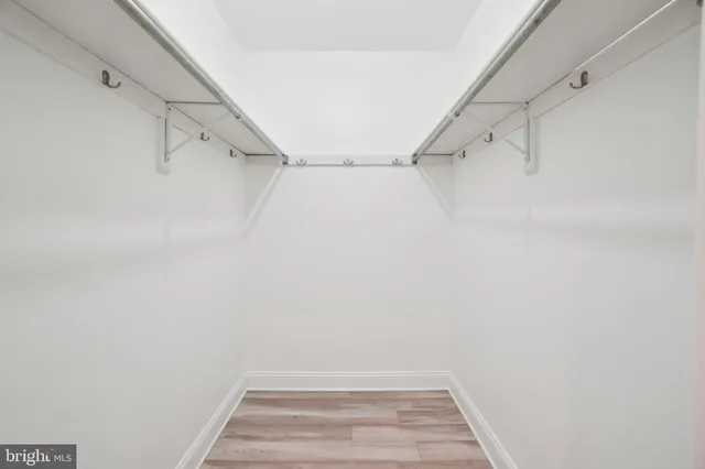 a view of walk in closet with empty racks