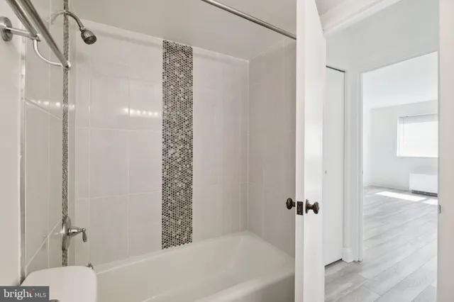 a bathroom with a bathtub and a shower