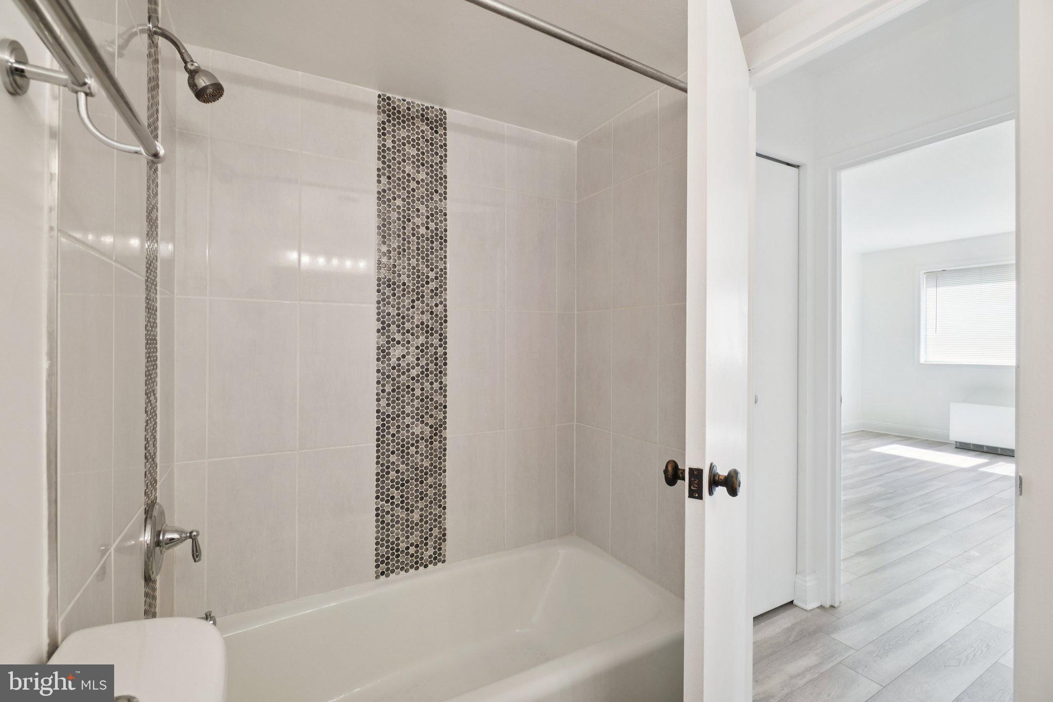 2059 Huntington Avenue, Unit 111 Alexandria, VA 22303 - Photo 24 of 34 a bathroom with a bathtub and a shower