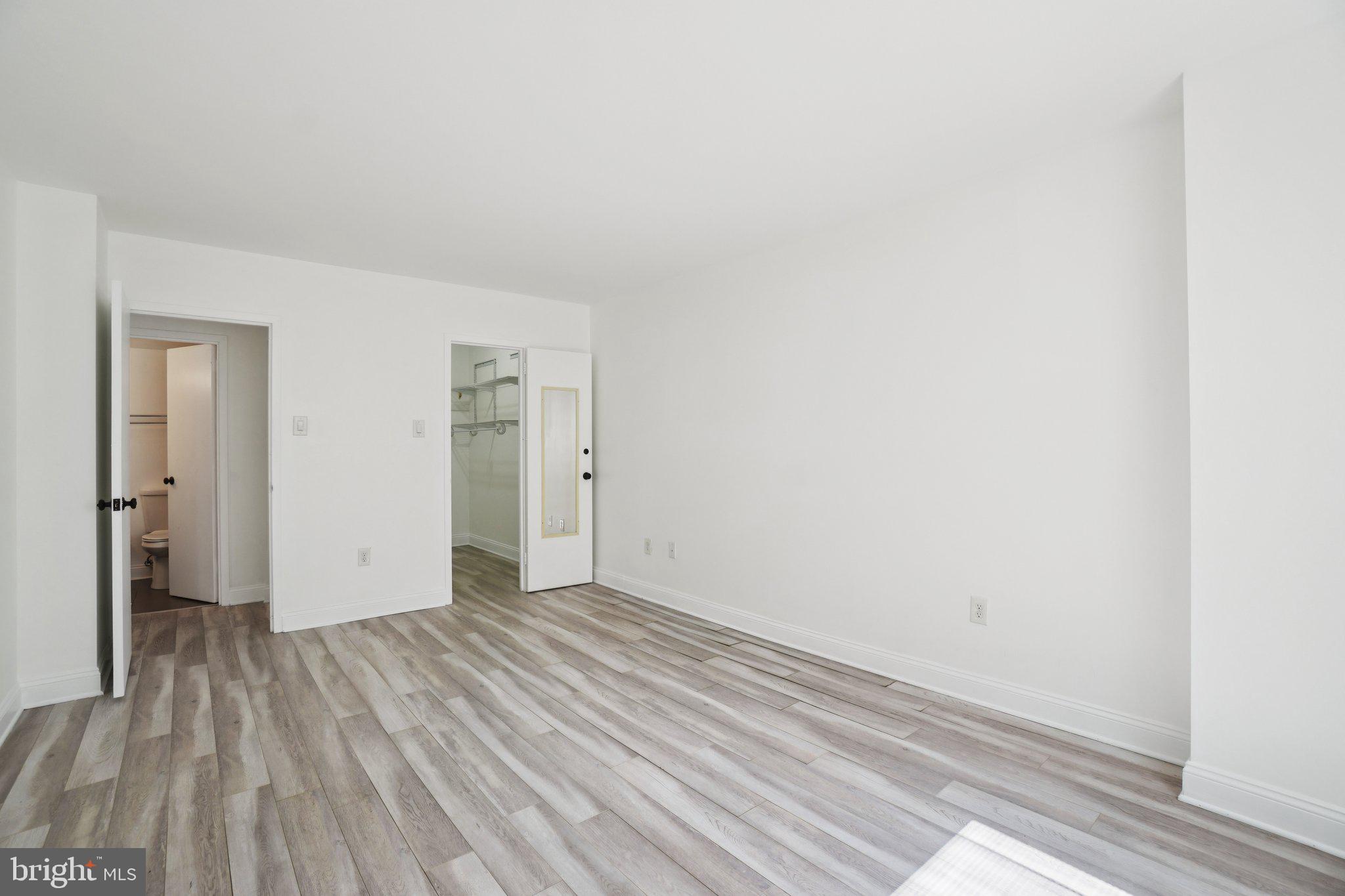 2059 Huntington Avenue, Unit 111 Alexandria, VA 22303 - Photo 25 of 34 a view of an empty room with wooden floor