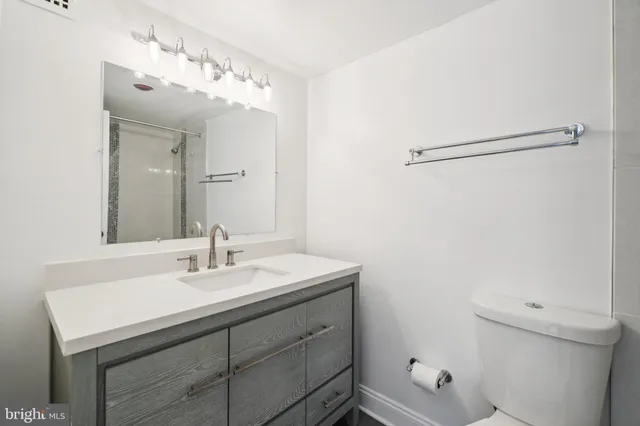 a bathroom with a sink vanity and a mirror