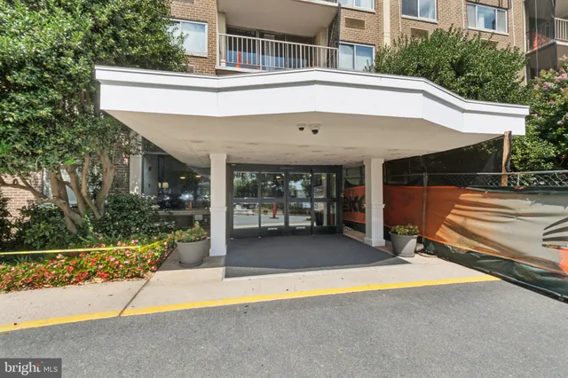 a view of a patio with a table and chairs under an umbrella
