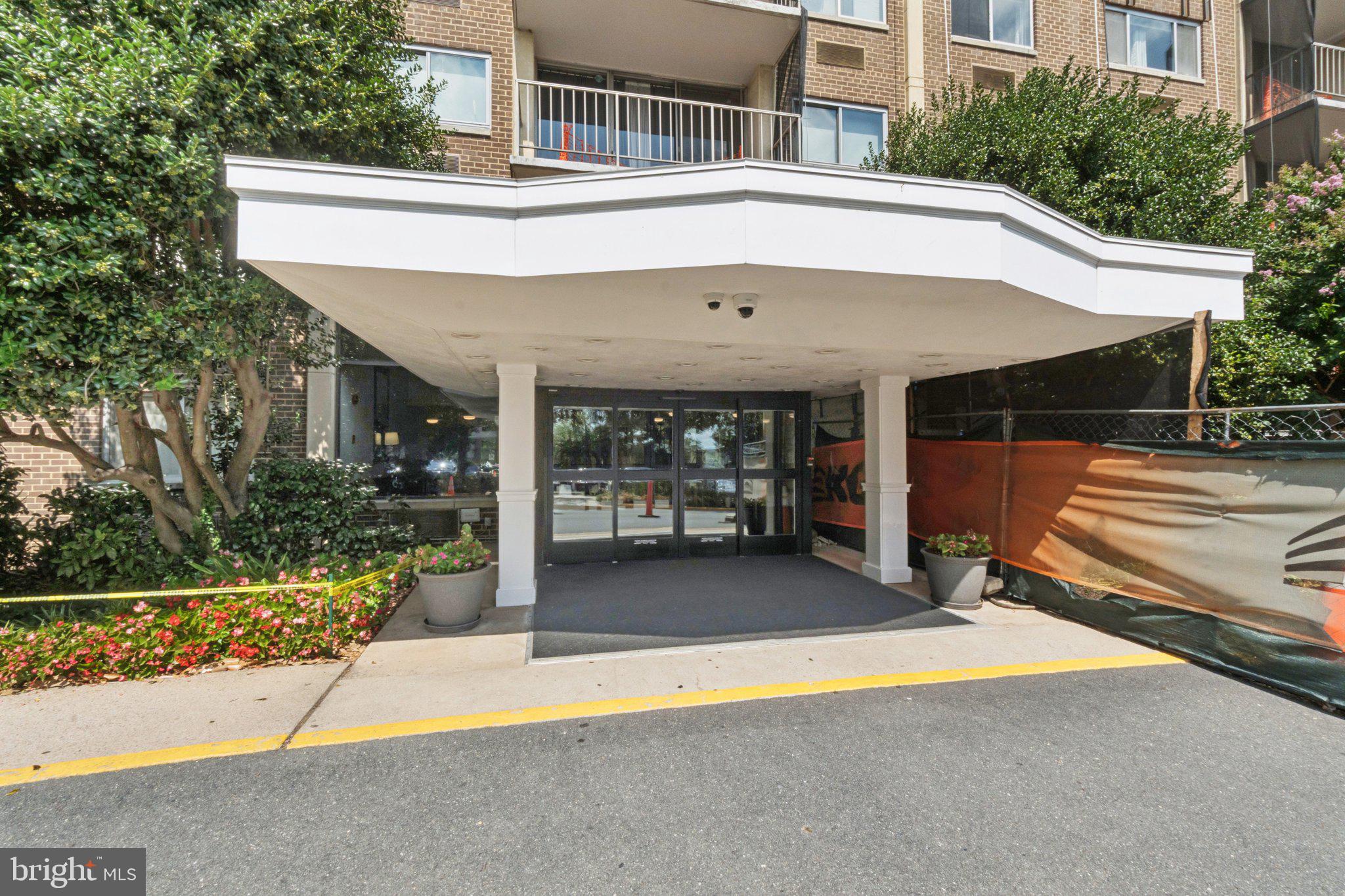 2059 Huntington Avenue, Unit 111 Alexandria, VA 22303 - Photo 3 of 34 a view of a patio with a table and chairs under an umbrella