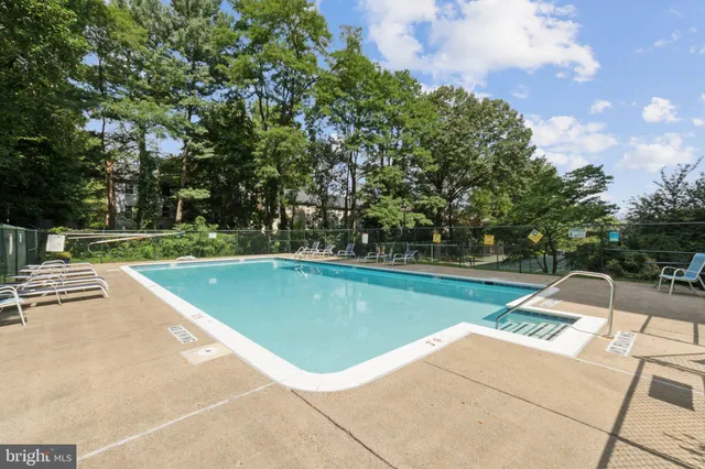 a view of a swimming pool with a yard