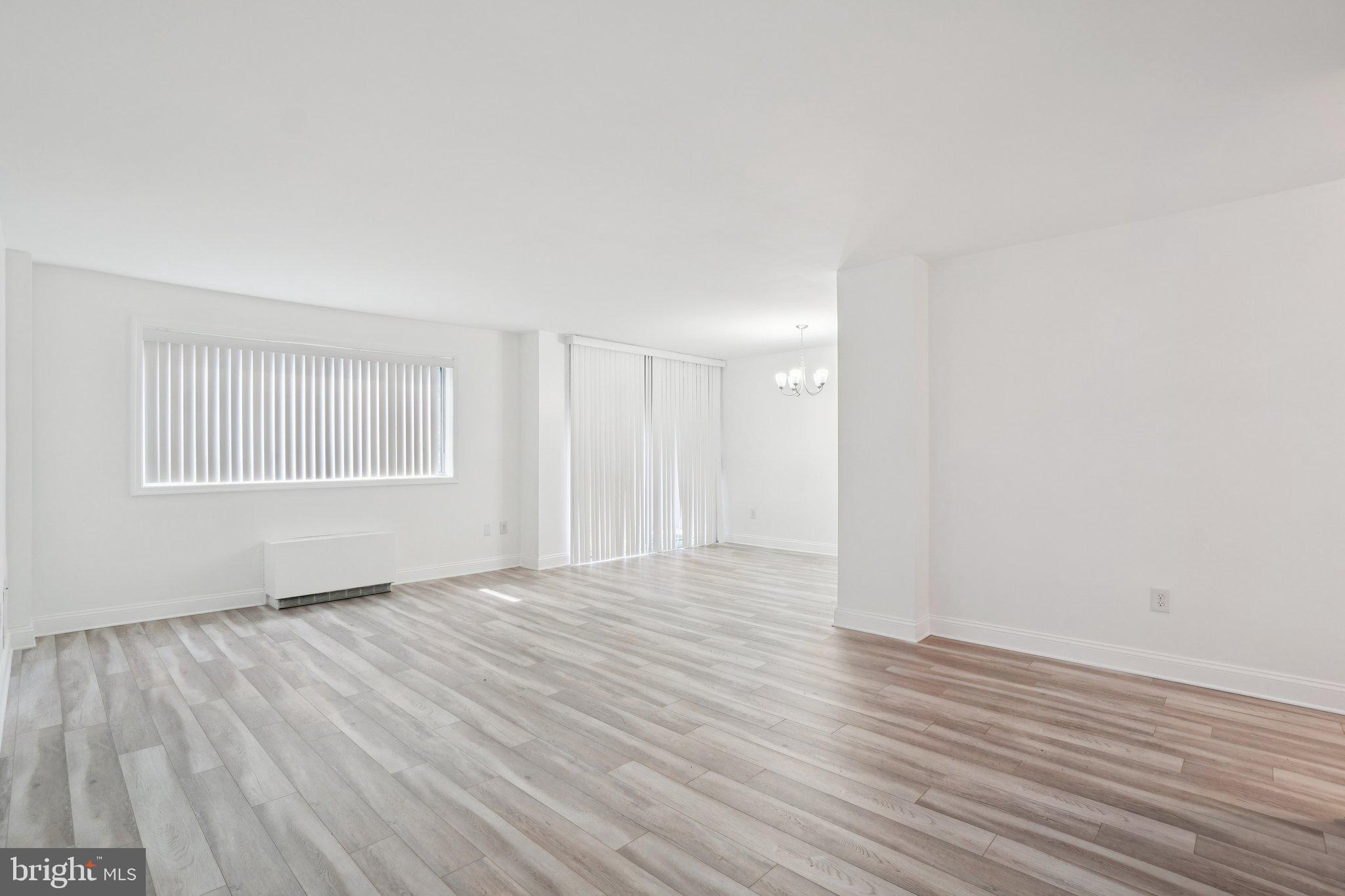 2059 Huntington Avenue, Unit 111 Alexandria, VA 22303 - Photo 6 of 34 a view of an empty room with wooden floor and a window