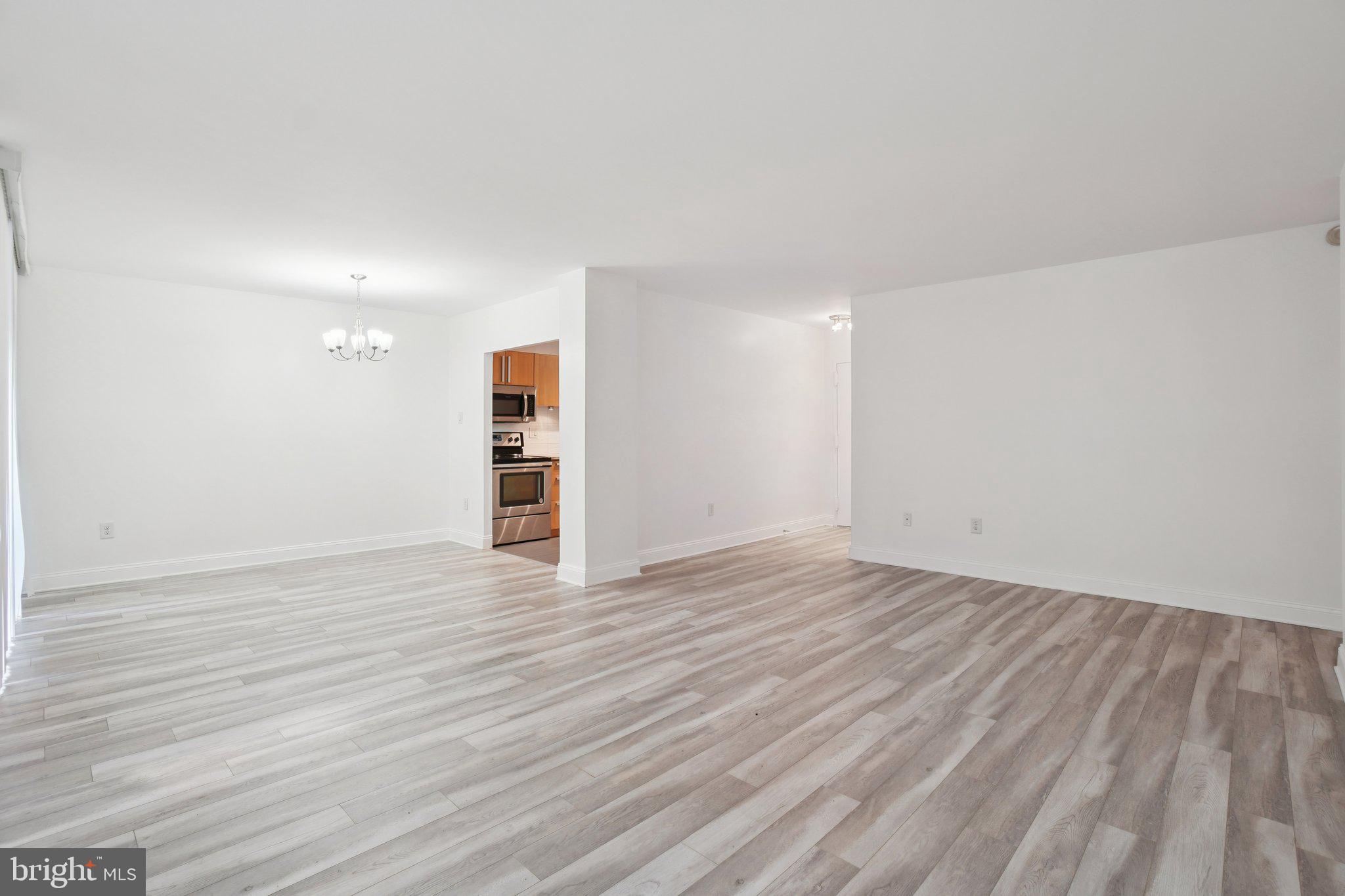 2059 Huntington Avenue, Unit 111 Alexandria, VA 22303 - Photo 8 of 34 a view of empty room with wooden floor and window