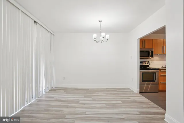 a view of a kitchen with cabinets and stainless steel appliances
