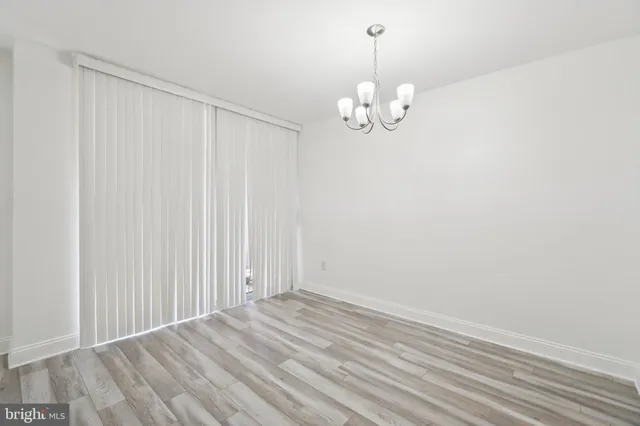 a view of a chandelier fan and wooden floor
