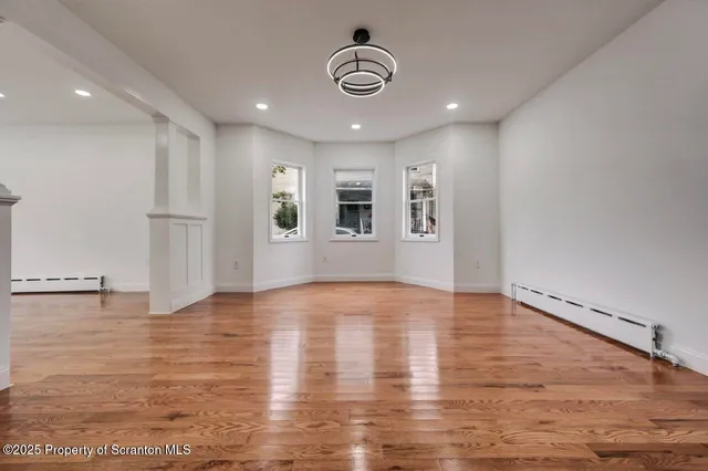 a kitchen with a white cabinets and chandelier