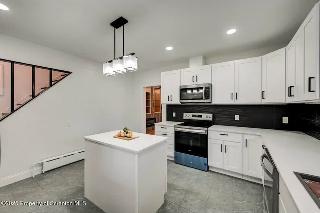 a view of livingroom with hardwood floor and kitchen view