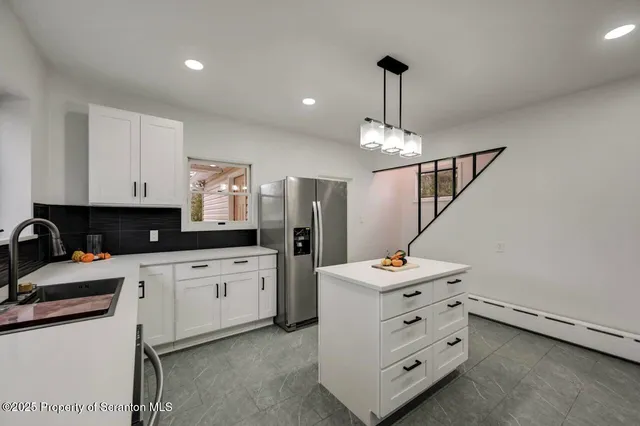 a view of a room with wooden floor and a window