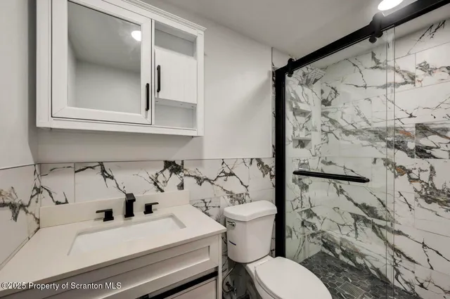 a bathroom with a bathtub and shower