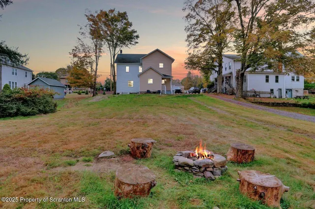 a view of empty room with wooden floor and window