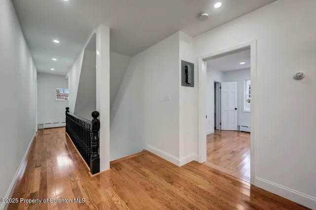 a view of staircase with wooden floor