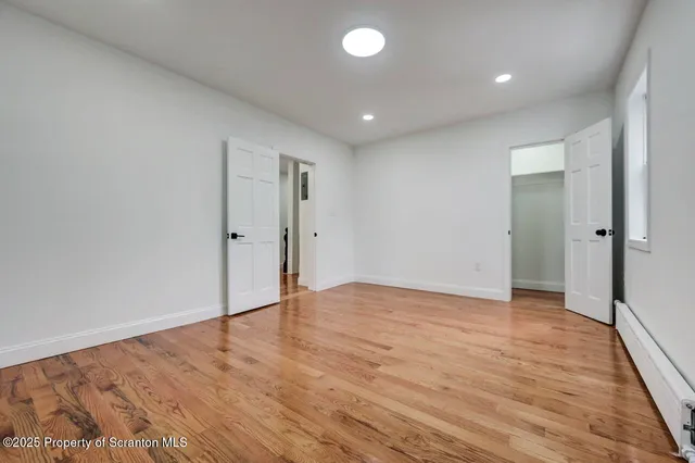 a view of a white house with a yard and table and chairs