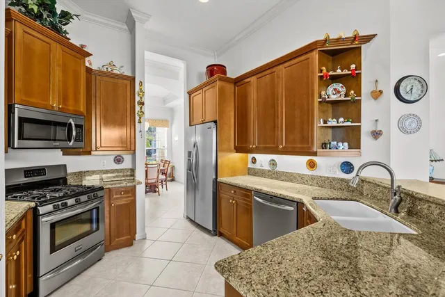 a kitchen with stainless steel appliances white cabinets and a stove top oven