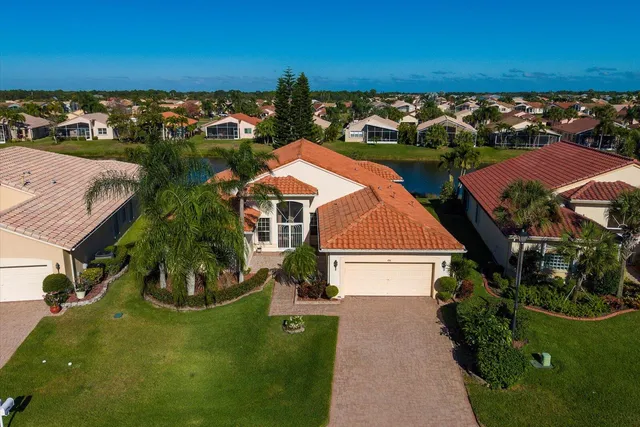 an aerial view of residential houses with outdoor space and river