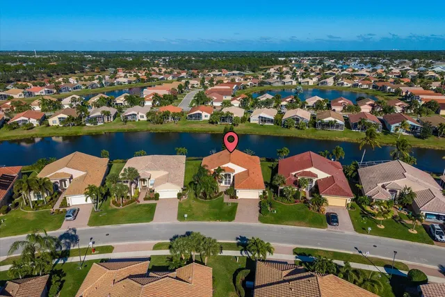 an aerial view of a house with a swimming pool and outdoor seating