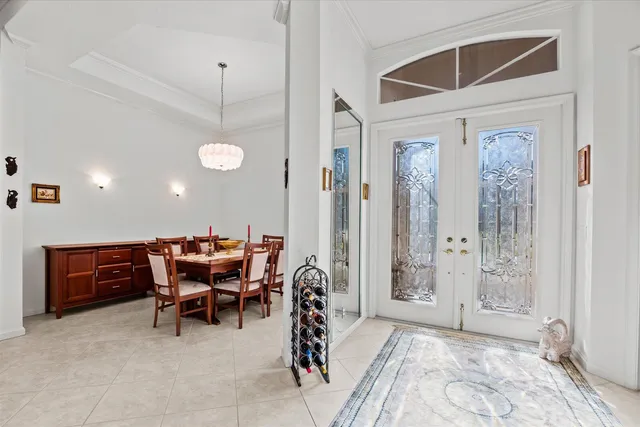 a dining room with a wooden table and chairs