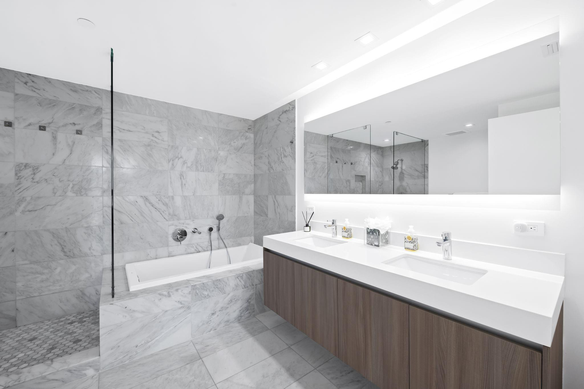 401 North Birch Road, Unit 1100 Fort Lauderdale, FL 33304 - Photo 11 of 30 a bathroom with a double vanity sink mirror and a bathtub