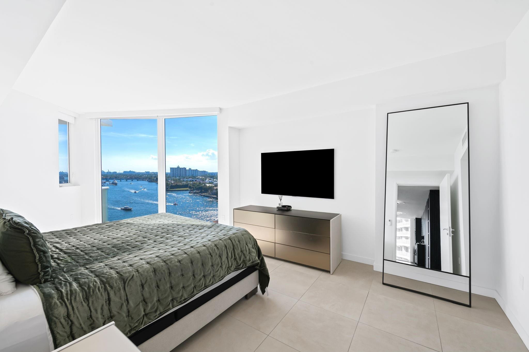 401 North Birch Road, Unit 1100 Fort Lauderdale, FL 33304 - Photo 8 of 30 a bedroom with a bed and a flat screen tv