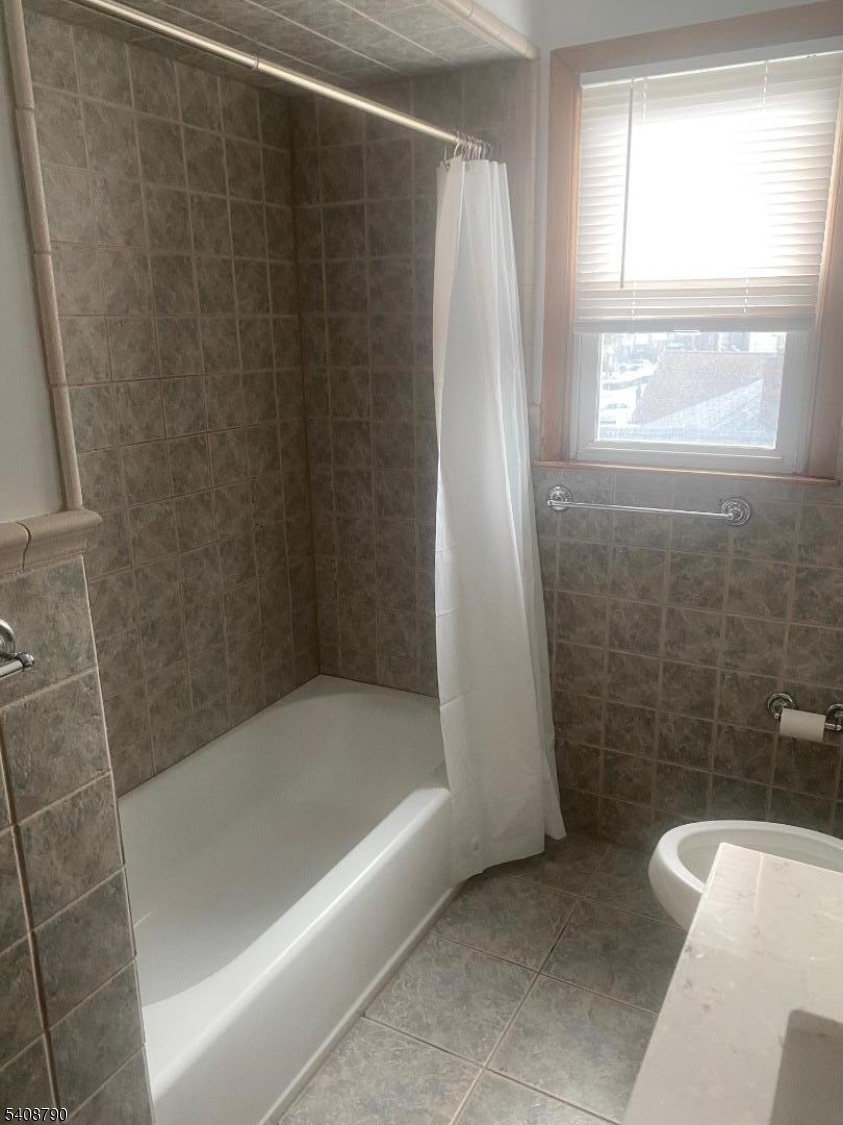 423 Clarkson Avenue, Unit 2 Elizabeth, NJ 07202 - Photo 7 of 16 a bathroom with a shower and a bathtub