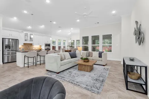 a living room with furniture and kitchen view