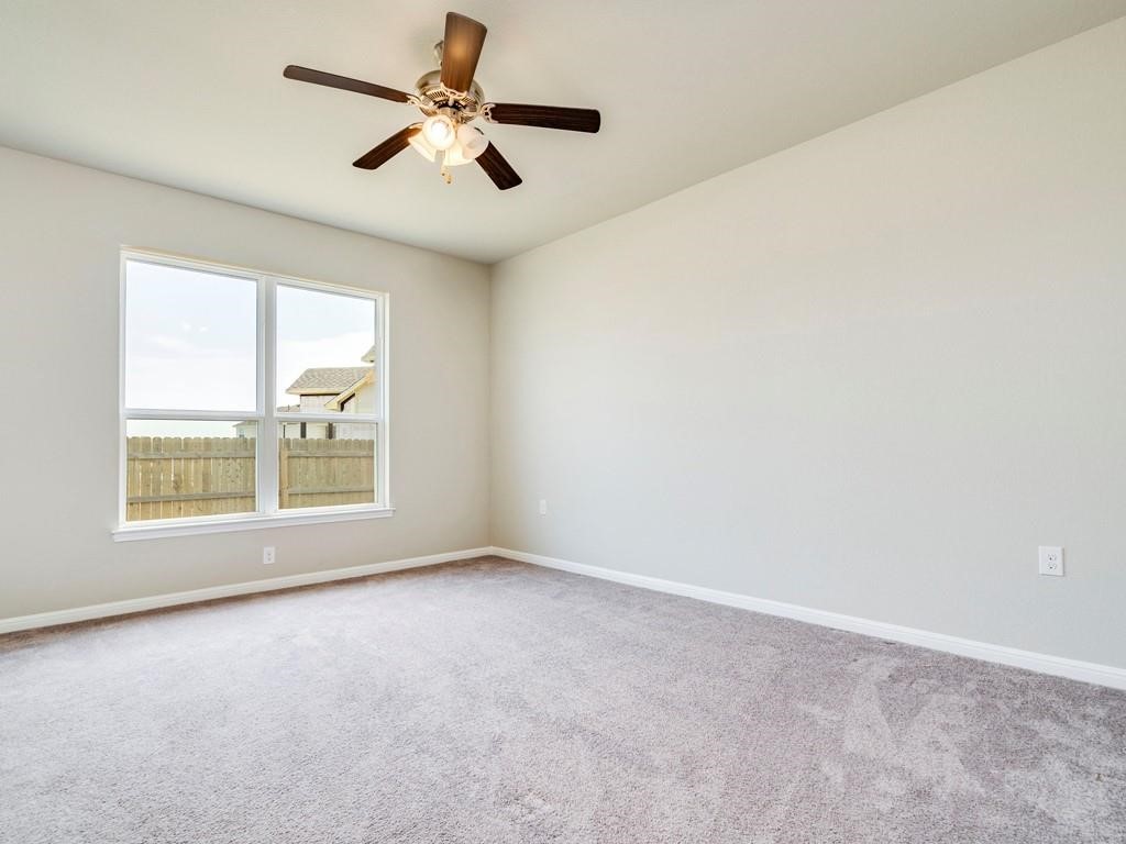 4210 Birdwatch Loop, Unit 2 Pflugerville, TX 78660 - Photo 14 of 31 Well-lit and spacious, this bedroom offers comfortable living with soft carpeting and an integrated ceiling fan.