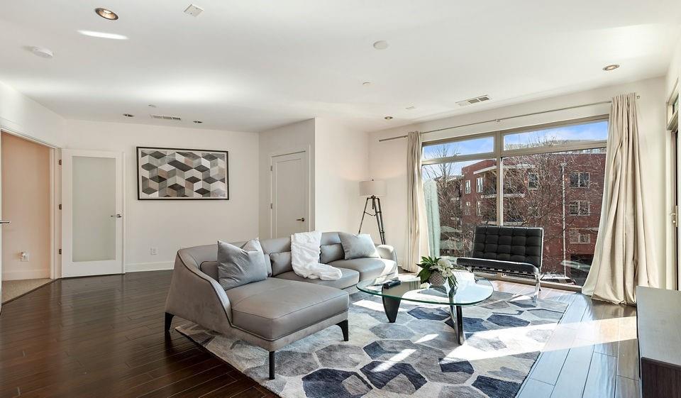 1045 Piedmont Avenue Northeast, Unit 1B1BA Atlanta, GA 30309 - Photo 6 of 16 a living room with furniture and a fireplace