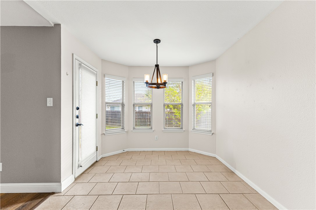 3709 Springfield Drive College Station, TX 77845 - Photo 9 of 23 an empty room with windows and chandelier