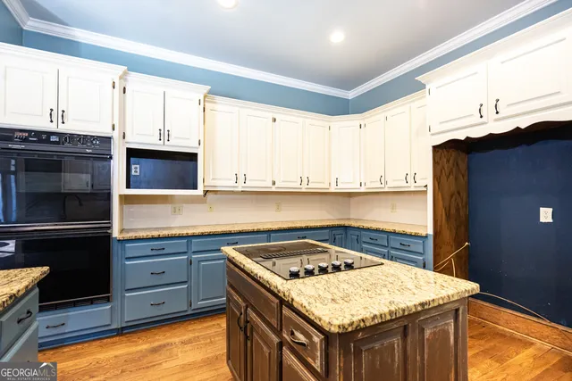 a kitchen with stainless steel appliances granite countertop a sink stove and cabinets