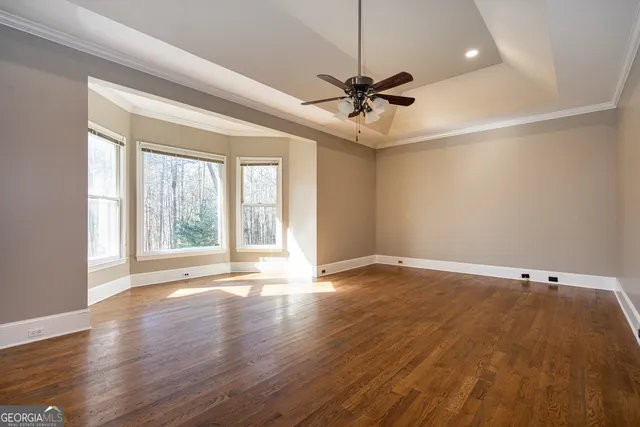 a view of a room that has a large window and front door