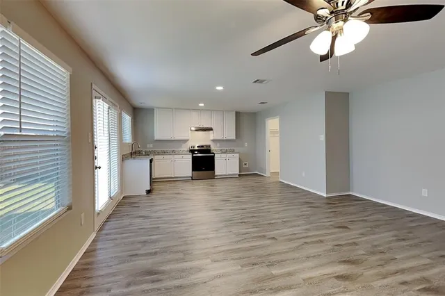 a view of a kitchen with a stove cabinets and wooden floor