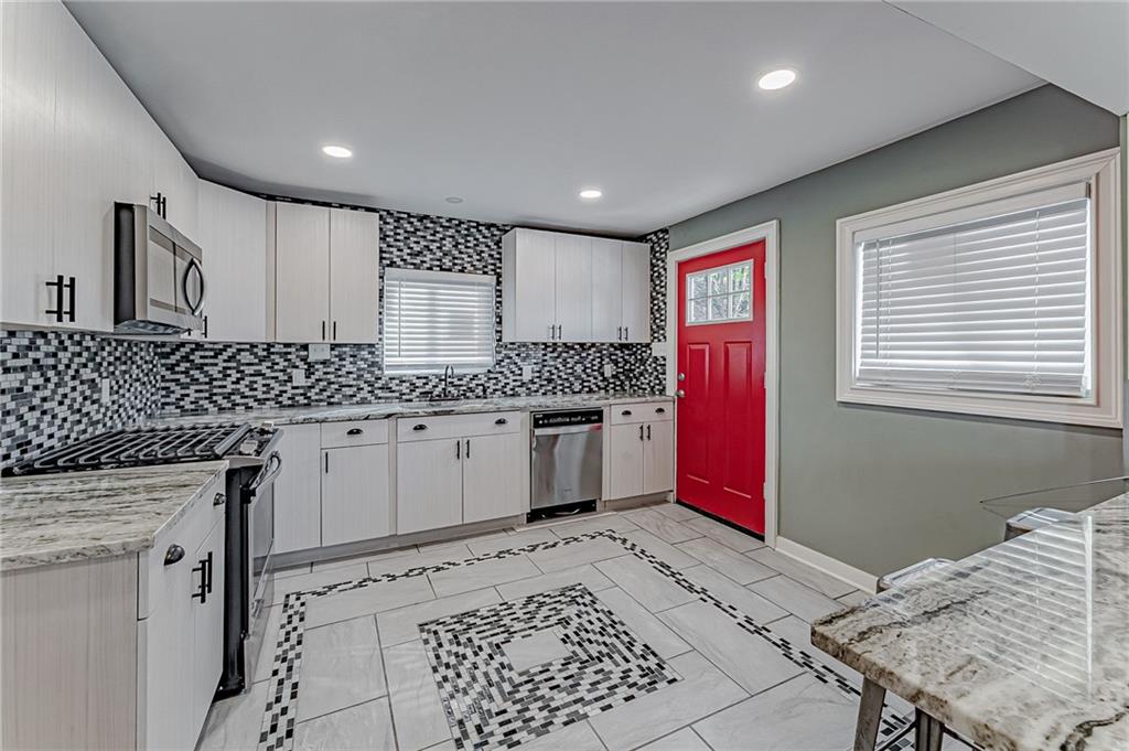 414 Hochberg Road Pittsburgh, PA 15235 - Photo 12 of 23 a kitchen with a stove sink and cabinets