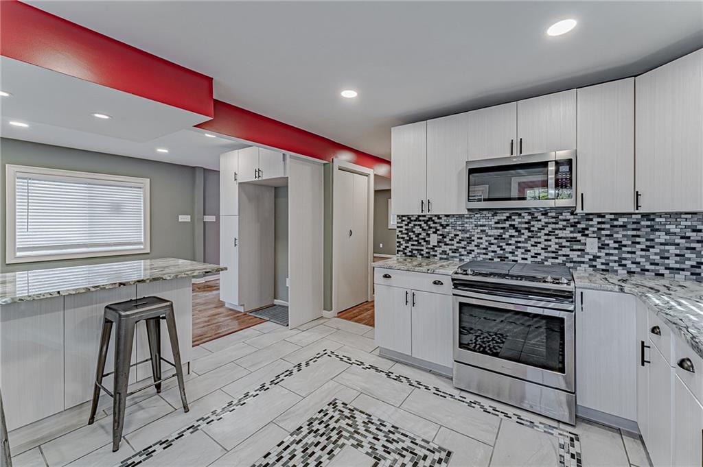 414 Hochberg Road Pittsburgh, PA 15235 - Photo 15 of 23 a kitchen with stainless steel appliances granite countertop a stove a sink and a refrigerator