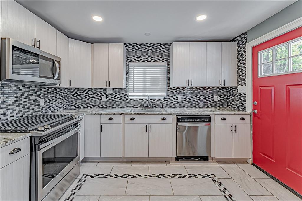 414 Hochberg Road Pittsburgh, PA 15235 - Photo 16 of 23 a kitchen with granite countertop white cabinets and stainless steel appliances