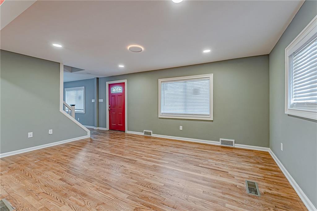 414 Hochberg Road Pittsburgh, PA 15235 - Photo 4 of 23 a view of an empty room with wooden floor and a window