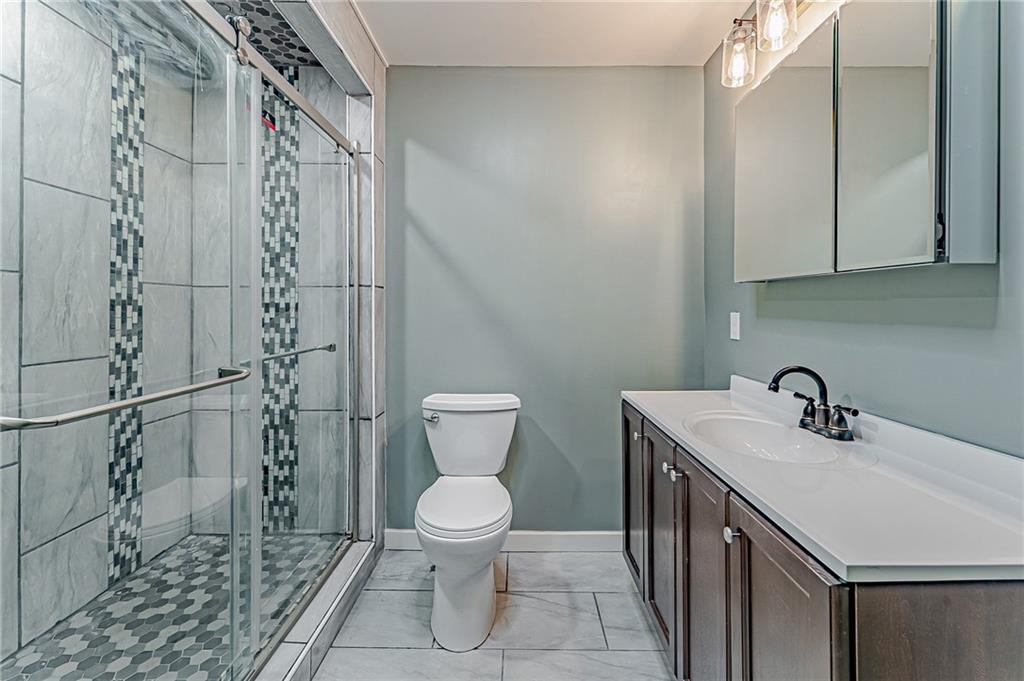 414 Hochberg Road Pittsburgh, PA 15235 - Photo 6 of 23 a bathroom with a sink a toilet and shower