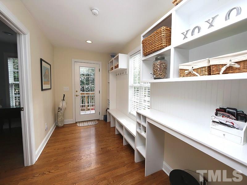 2501 Bredon Court Raleigh, NC 27613 - Photo 13 of 25 a hallway with wooden floors and cabinet