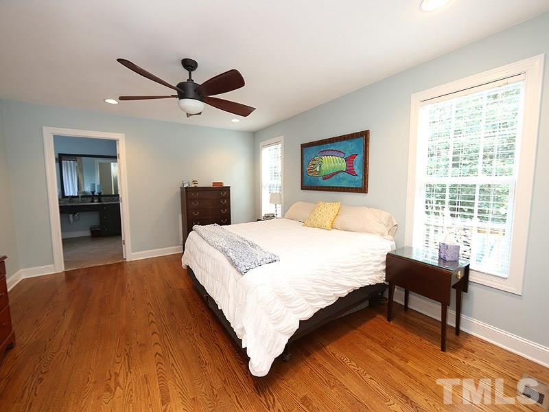 2501 Bredon Court Raleigh, NC 27613 - Photo 14 of 25 a bedroom with a bed and a large window