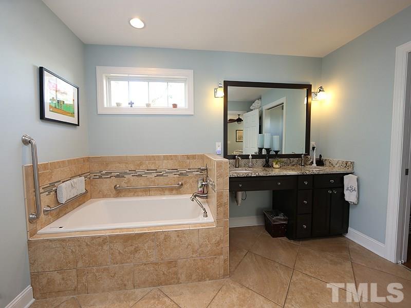 2501 Bredon Court Raleigh, NC 27613 - Photo 15 of 25 a bathroom with a bathtub sink and mirror