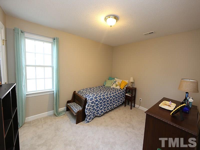 2501 Bredon Court Raleigh, NC 27613 - Photo 19 of 25 a bedroom with a bed and a window