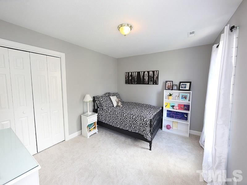 2501 Bredon Court Raleigh, NC 27613 - Photo 21 of 25 a bedroom with a bed and a cabinets
