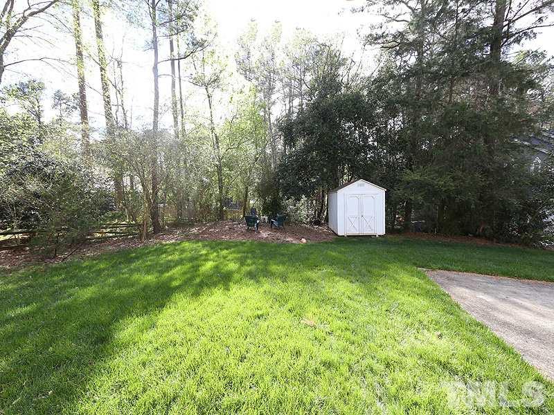 2501 Bredon Court Raleigh, NC 27613 - Photo 23 of 25 a backyard of a house with trees and outdoor seating