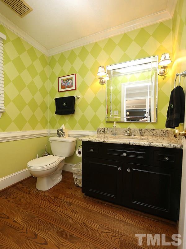 2501 Bredon Court Raleigh, NC 27613 - Photo 25 of 25 a bathroom with a sink vanity mirror and toilet