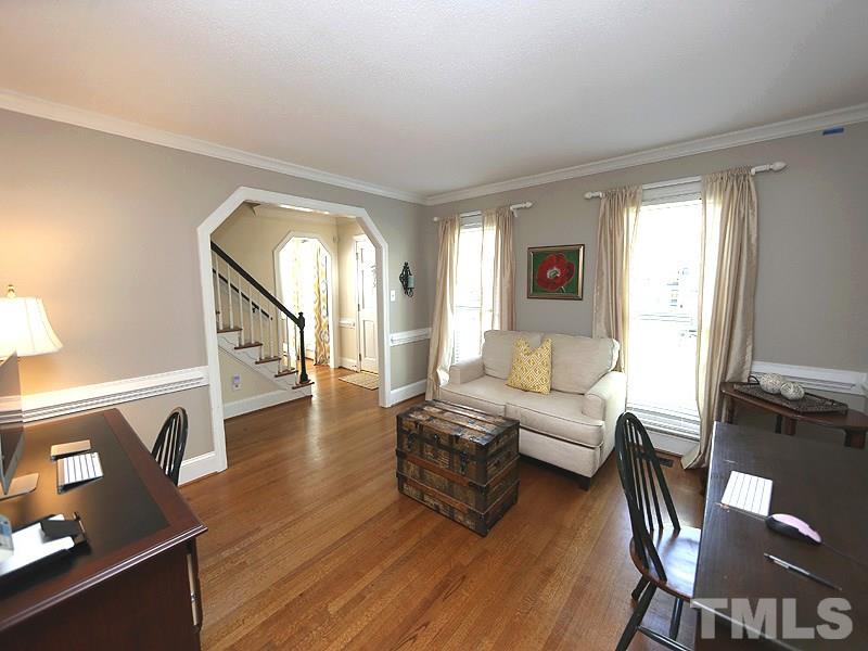 2501 Bredon Court Raleigh, NC 27613 - Photo 4 of 25 a living room with couches and a flat screen tv with wooden floor